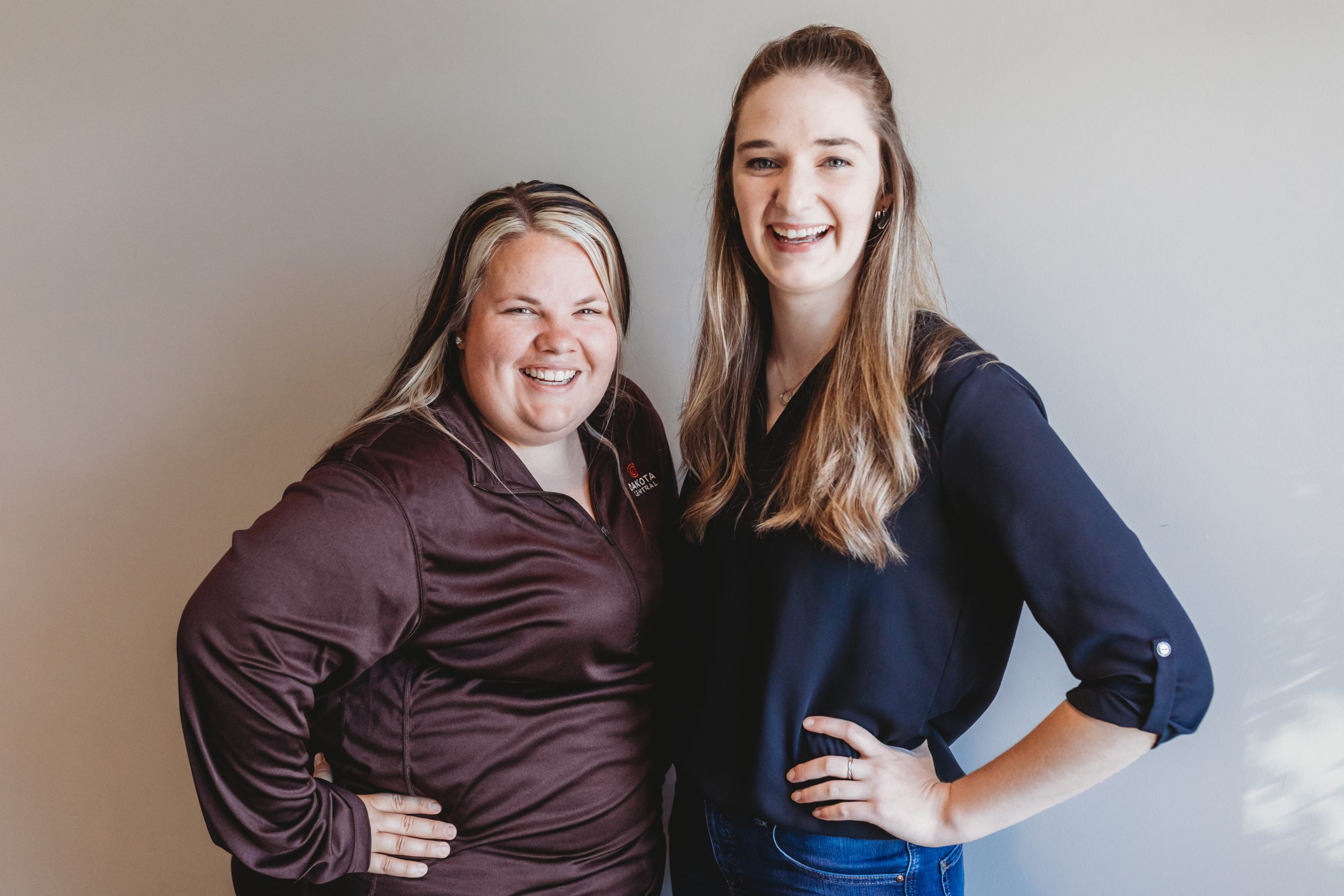 Team photo of two smiling customer relations team members.